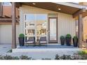 Charming front porch features seating and stylish potted plants, enhancing curb appeal at 3734 Ridgeway St, Boulder, CO 80301