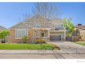 Charming two-story home featuring stone accents, a front porch, and a two-car garage at 4119 Riley Dr, Longmont, CO 80503