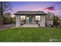 Charming single-story home with well-manicured lawn and inviting blue front door at 5383 Meade St, Denver, CO 80221