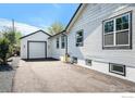 A detached garage sits at the end of a long driveway at 5383 Meade St, Denver, CO 80221