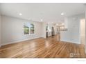 Bright, open-concept living room with hardwood floors, flowing into adjacent spaces at 5383 Meade St, Denver, CO 80221