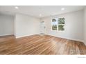 Bright living room with hardwood floors, large window, and neutral paint at 5383 Meade St, Denver, CO 80221