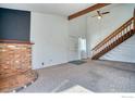 Inviting living room area with brick fireplace and open staircase to the second floor at 607 5Th St, Frederick, CO 80530