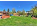 Spacious backyard featuring a hot tub, above ground pool and a beautiful garden area with wooden beams at 700 33Rd St, Boulder, CO 80303