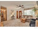 Cozy living room featuring a ceiling fan, wood floors, area rug, and natural light from front window at 700 33Rd St, Boulder, CO 80303