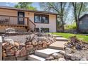 Beautifully landscaped front yard with rock features, walkway, and a well-maintained lawn at 7240 Glacier View Rd, Longmont, CO 80503