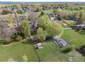 A sprawling backyard with a garden, play area, trampoline, and solar panels in a lush green landscape at 7628 Estate Cir, Niwot, CO 80503