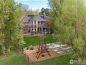 Expansive backyard featuring a play set, a well-manicured lawn, and a charming covered patio at 7628 Estate Cir, Niwot, CO 80503