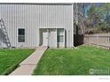 Charming property with a well-kept lawn, vertical siding, and a cozy entrance at 8050 Niwot Rd # 37, Niwot, CO 80503