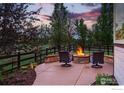 Cozy patio area with a stone fire pit and comfortable seating, perfect for outdoor relaxation at 119 Ortega Ct, Erie, CO 80516