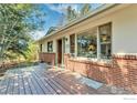 Charming home with a wood deck, brick accents, and large windows for ample natural light at 1245 Claremont Dr, Boulder, CO 80305