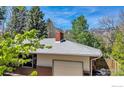 Side view of the house showcasing the brick facade and showing the roof, and attached garage at 1245 Claremont Dr, Boulder, CO 80305