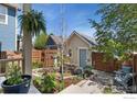 Serene backyard with a well-kept garden, stone pathway, storage shed, and relaxing outdoor seating at 1278 Hummingbird Cir # D, Longmont, CO 80501
