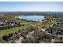 Stunning aerial view showcases a home near a serene lake and lush green spaces at 1809 Keel Ct, Lafayette, CO 80026