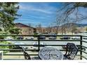 Balcony view showcasing an ornate metal table and chairs, and a cityscape in the background at 1825 Marine St # 8, Boulder, CO 80302