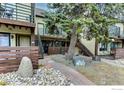 Exterior of a multi-story building with balconies, stairs, and a landscaped courtyard featuring rocks and pavers at 1825 Marine St # 8, Boulder, CO 80302