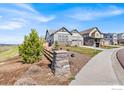 Exterior view of a landscaped front yard featuring a well maintained lawn with a decorative stone fence at 1839 Pinion Wing Cir, Castle Rock, CO 80108
