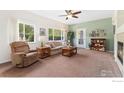 Cozy living room with plush carpeting, large windows, and comfortable furnishings at 2239 Calais Dr # F, Longmont, CO 80504