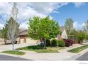 Charming brick and siding home with a well-manicured lawn, mature trees, and three-car garage at 2304 Dogwood Dr, Erie, CO 80516