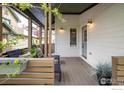Inviting covered porch featuring neutral tones, ambient lighting, and comfortable outdoor seating at 2552 Stonewall Ln, Lafayette, CO 80026