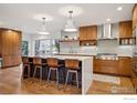 Modern kitchen features a large island with seating, stainless steel appliances, and a large window at 2575 Cragmoor Rd, Boulder, CO 80305
