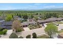 Spacious suburban home with a lush green lawn and mature trees at 2721 Villanova Ct, Longmont, CO 80503