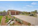 Charming home featuring a two-car garage and lush front yard landscaping at 2721 Villanova Ct, Longmont, CO 80503