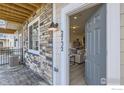 Inviting entryway showcasing the home's facade with stone accents and views of the interior at 2732 Bear Springs Cir, Longmont, CO 80503