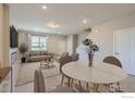 Bright open-concept living area with neutral tones, modern furnishings, and ample natural light at 2732 Bear Springs Cir, Longmont, CO 80503