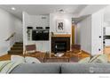 Cozy living room featuring a fireplace, built-in shelving, and hardwood floors at 3272 Big Horn St, Boulder, CO 80301