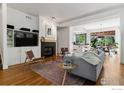 Open-concept living room with fireplace, wood floors, and comfortable seating arrangement at 3272 Big Horn St, Boulder, CO 80301