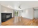 Spacious living room featuring hardwood floors, a cozy fireplace, and sliding glass doors for natural light at 3785 Birchwood Dr # 69, Boulder, CO 80304