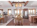 Open-concept living and dining area with vaulted ceilings, exposed beams, and scenic views at 399 Northview Rd, Berthoud, CO 80513