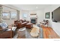 Cozy living room with a fireplace, plush seating, and natural light at 4212 E Orchard Pl, Centennial, CO 80121