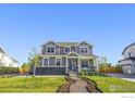 Beautiful two-story home featuring a stone facade and a meticulously landscaped front yard at 437 Buckskin Rd, Berthoud, CO 80513