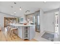 Well-designed kitchen featuring gray cabinets, a center island with seating, and stainless steel appliances at 4965 Ricara Dr, Boulder, CO 80303