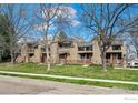 Desirable street view showcasing well-maintained townhomes with mature trees, fences, and lawns at 5086 Buckingham Rd, Boulder, CO 80301