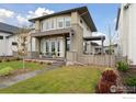 Stylish two-story home with a modern exterior, lush lawn and a covered patio for outdoor relaxation at 608 W Grange Ct, Longmont, CO 80503