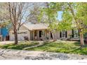 Inviting single-story home with a stone-accented facade, cozy front porch, and beautifully landscaped front yard at 642 W Chestnut Ct, Louisville, CO 80027