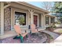 Charming covered front porch with stone accents and outdoor seating at 642 W Chestnut Ct, Louisville, CO 80027