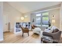 Bright living room featuring vaulted ceilings, hardwood floors, and large windows at 709 Buchanan Ln, Longmont, CO 80504