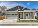 Charming single-Gathering home featuring a two-car garage and cozy front porch with seating at 741 Kohlor Dr, Lafayette, CO 80026