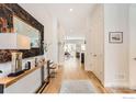Inviting hallway with hardwood floors, a console table, and modern decor at 741 Kohlor Dr, Lafayette, CO 80026