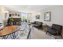 Bright living room with a fireplace, a balcony, comfortable seating, and a dining area at 805 29Th St # 308, Boulder, CO 80303