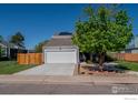 Inviting home featuring a well-maintained yard, solar panels and a two-car garage at 87 Macon Ct, Aurora, CO 80010