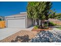 Charming home featuring a landscaped front yard, a garage, and a welcoming entrance at 87 Macon Ct, Aurora, CO 80010
