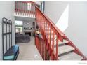 Inviting staircase with a beautiful wooden railing and a view to the living room at 87 Macon Ct, Aurora, CO 80010