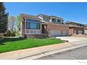 Charming two-story brick home with an attached two-car garage and well-maintained lawn at 1105 Oakhurst Dr, Broomfield, CO 80020