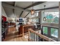Spacious living room showcasing a vaulted ceiling, brick fireplace, and ample natural light at 1561 Belmont Dr, Longmont, CO 80503