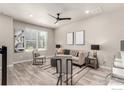 Well-lit living room with neutral tones, plank floors, and an open floor plan at 157 Ambrose St, Erie, CO 80516
